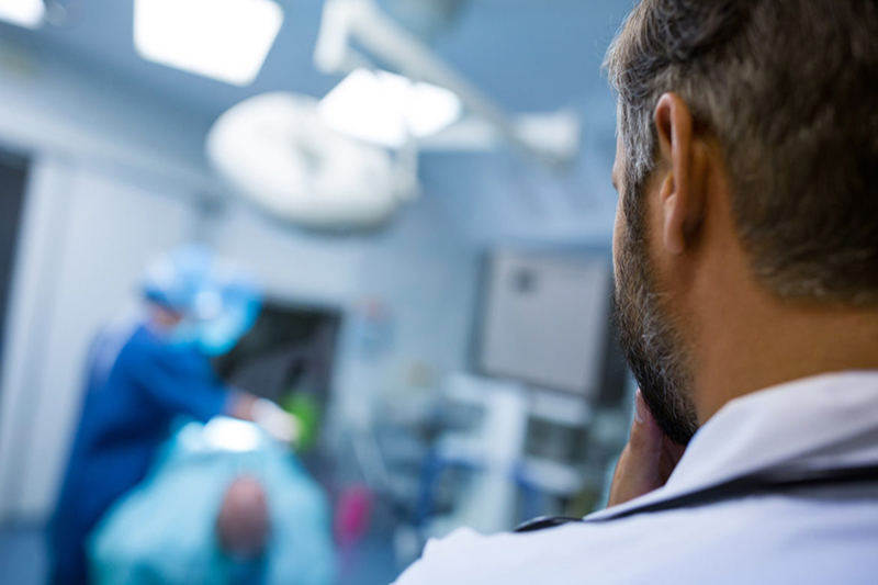 Surgeons performing operation in operation room